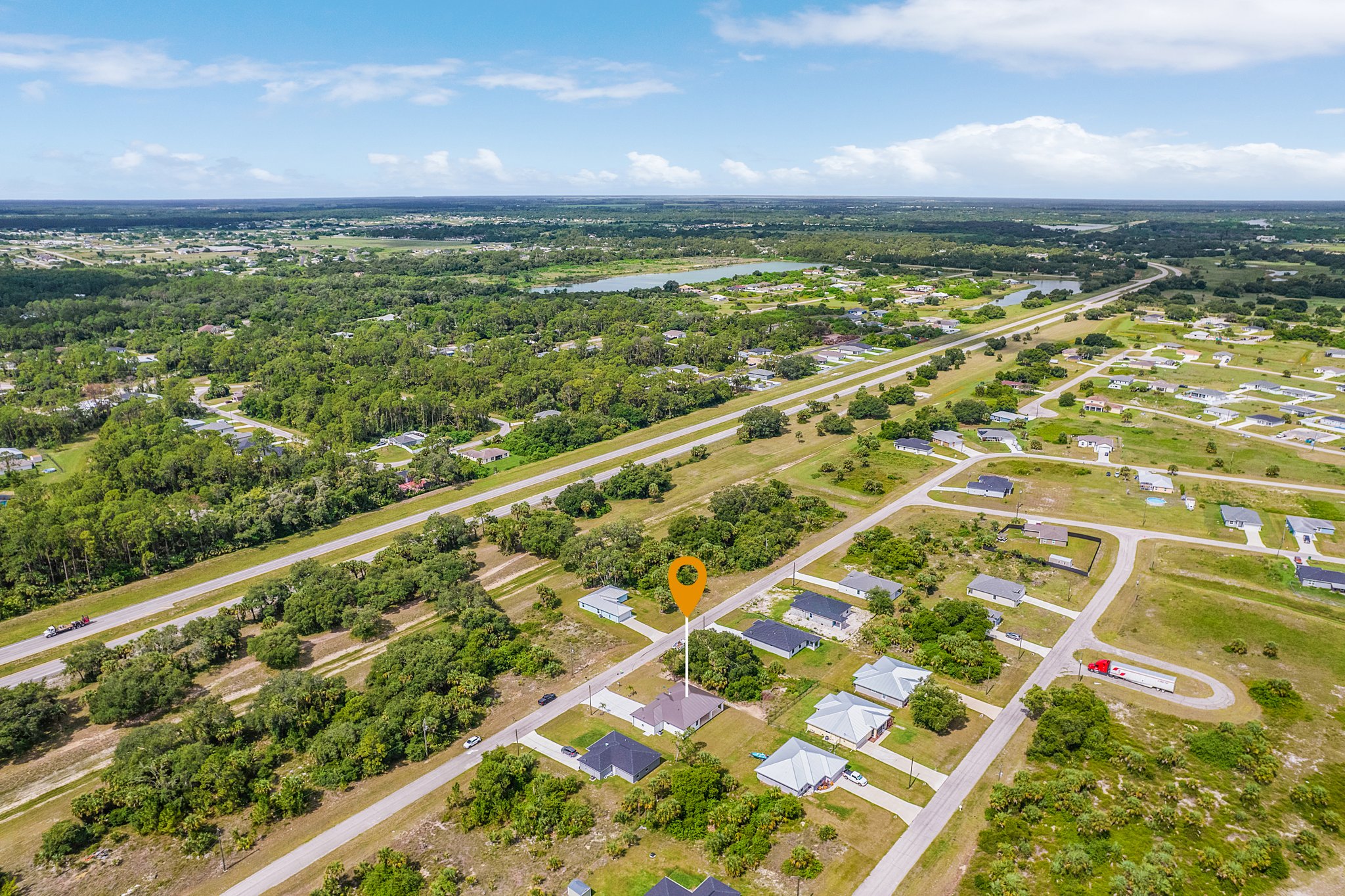 Aerial view of green vacant lots available for custom home building and development.