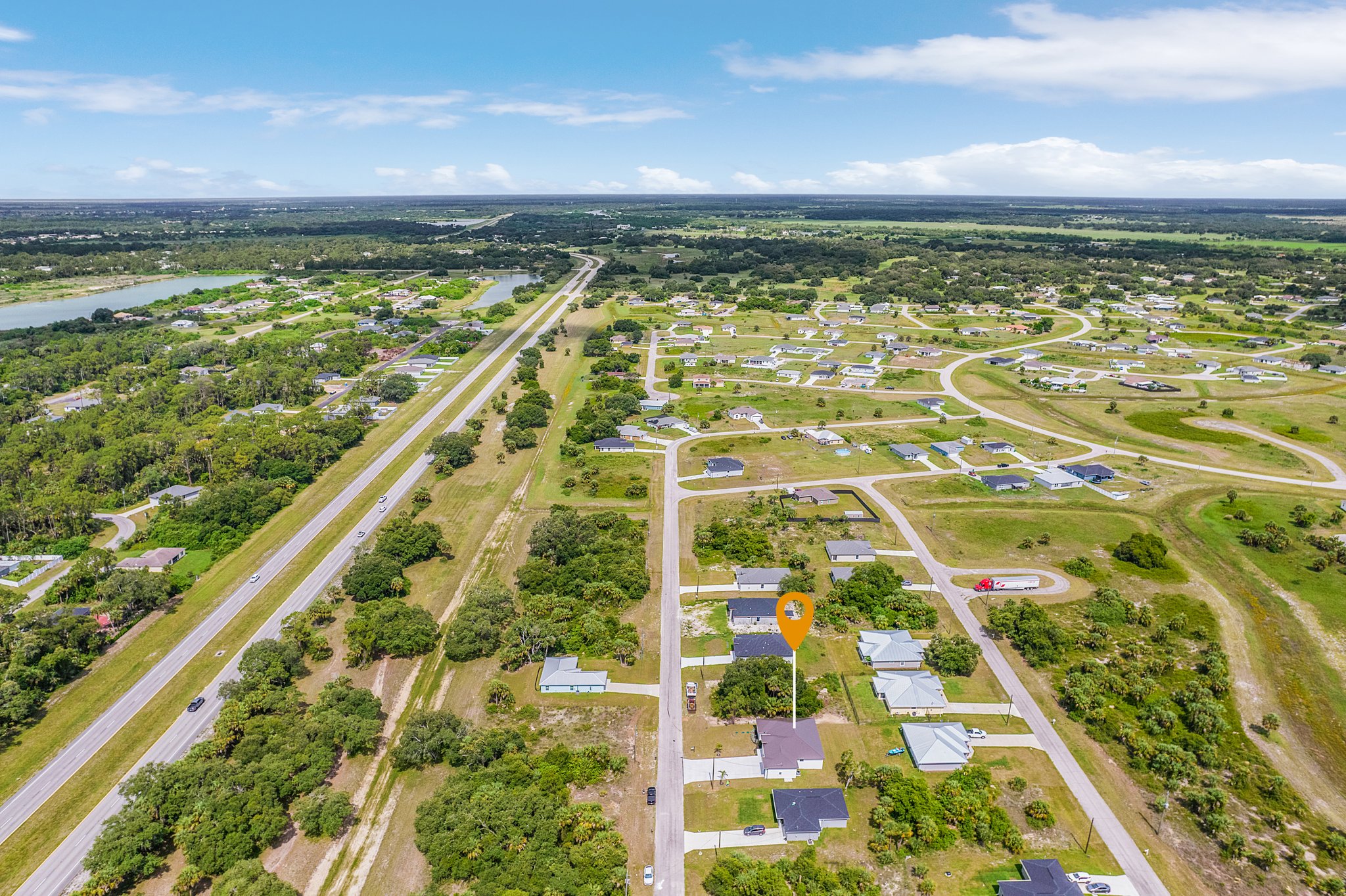 Aerial view of green vacant lots available for custom home building and development.