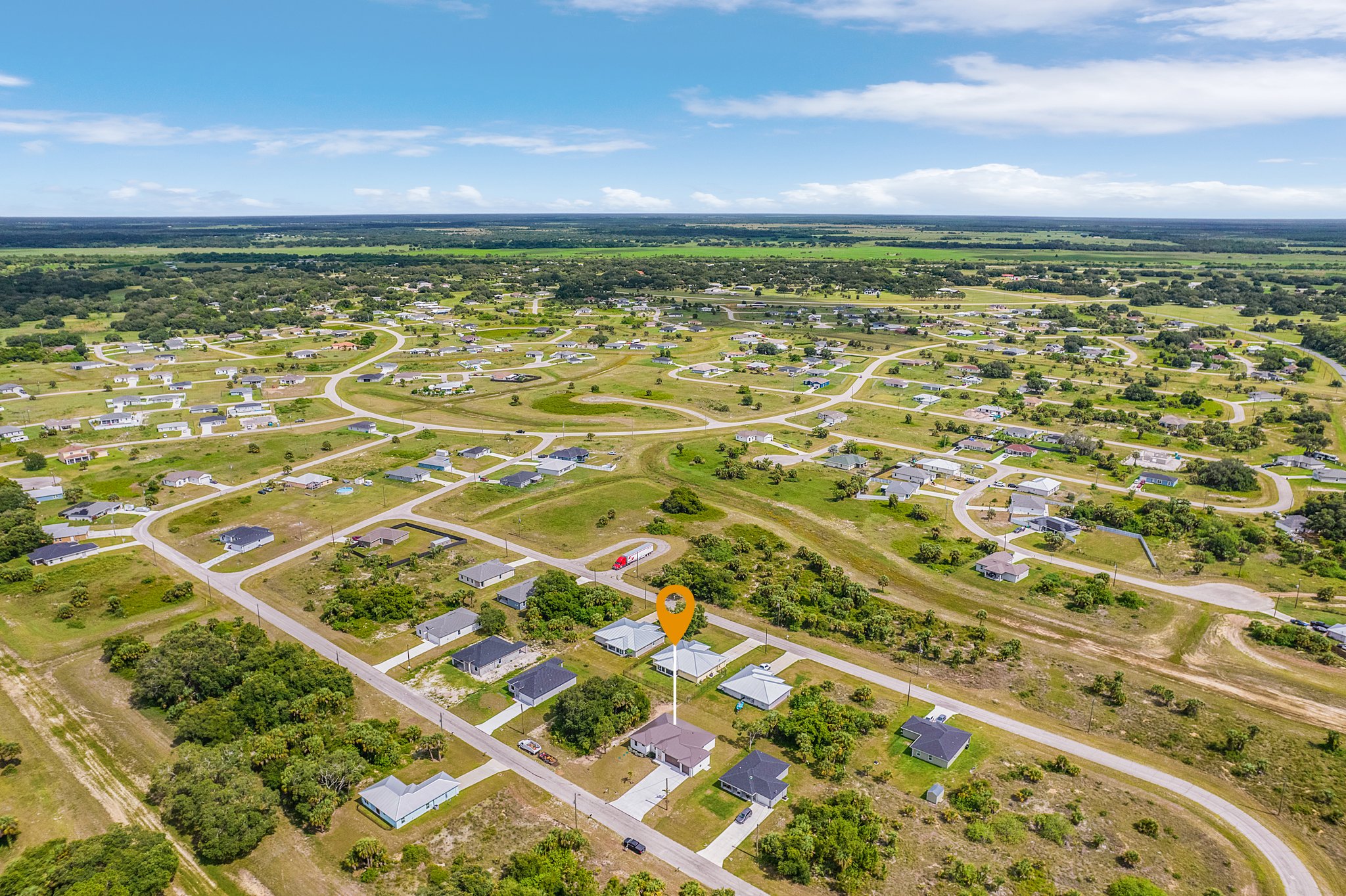 High-altitude aerial drone view of residential land plots and developing neighborhoods in Southwest Florida.